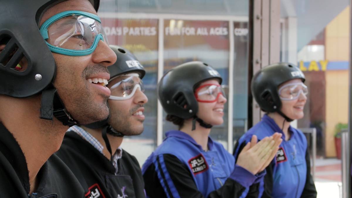 Four people with skydiving outfits on